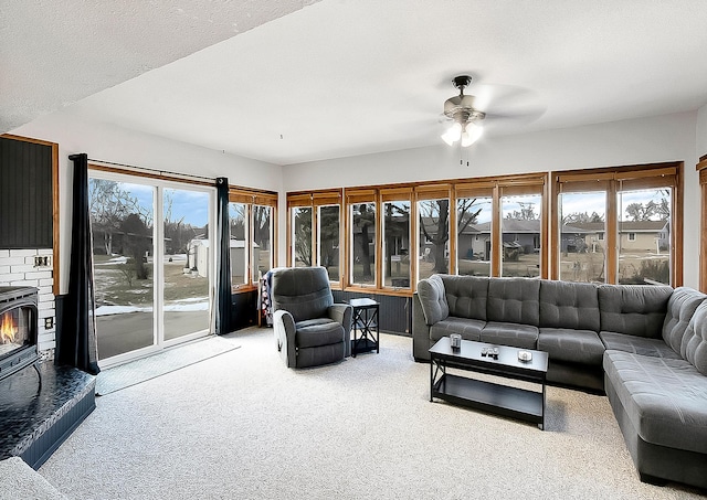 carpeted living room featuring ceiling fan