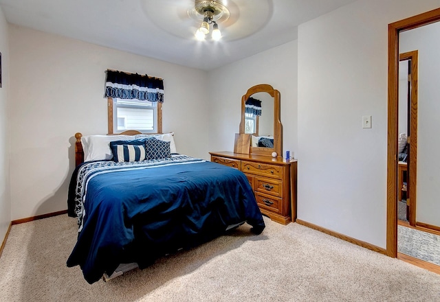 bedroom with light carpet and ceiling fan