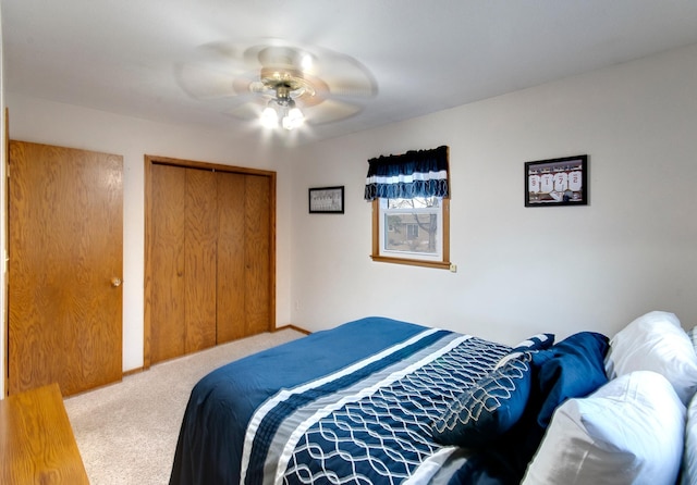 carpeted bedroom with ceiling fan and a closet