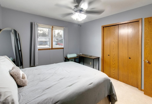 carpeted bedroom with a closet and ceiling fan