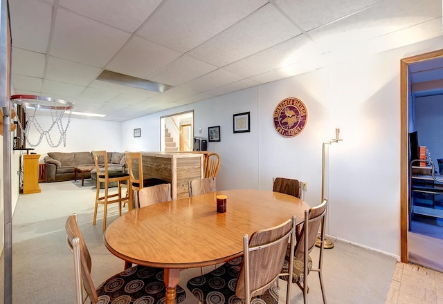 dining space with a paneled ceiling