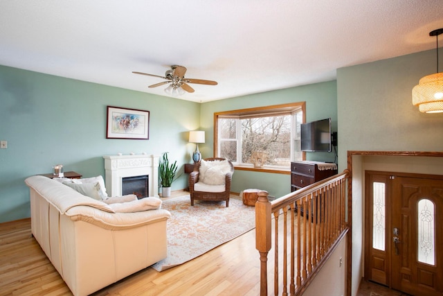 living room featuring ceiling fan and light wood-type flooring