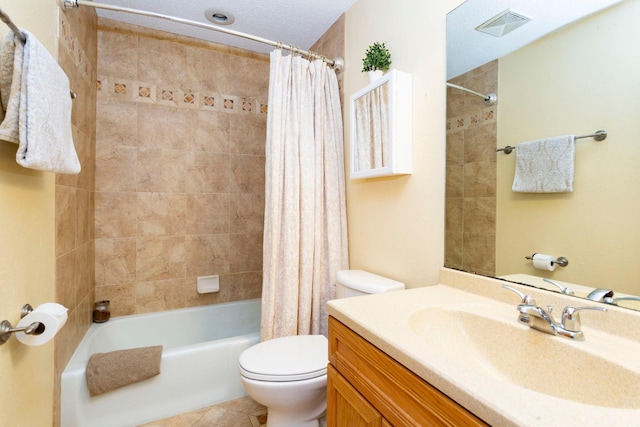 full bathroom featuring shower / tub combo with curtain, vanity, a textured ceiling, tile patterned floors, and toilet