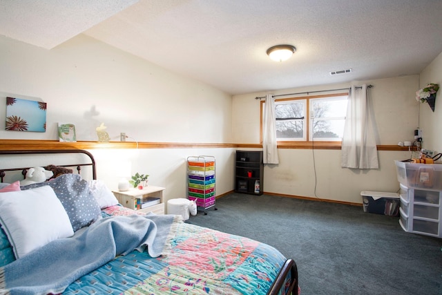 carpeted bedroom featuring a textured ceiling