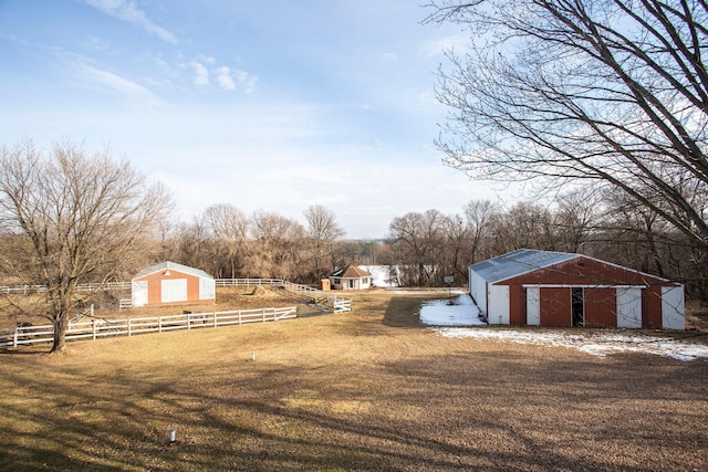 view of yard with a rural view and a storage shed