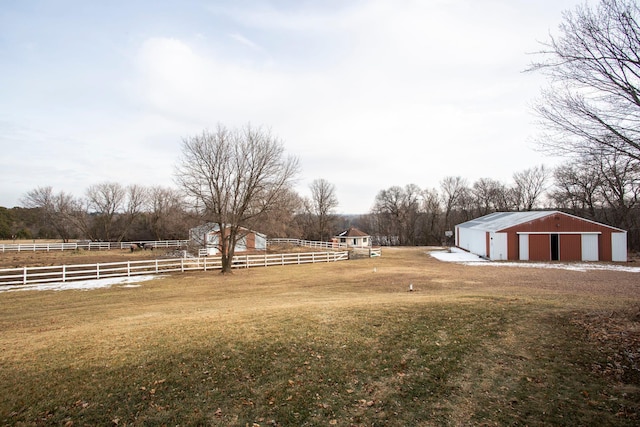 view of yard with a rural view and an outbuilding