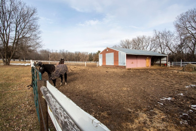 view of yard with a rural view and an outbuilding