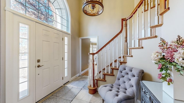 tiled entryway featuring a high ceiling