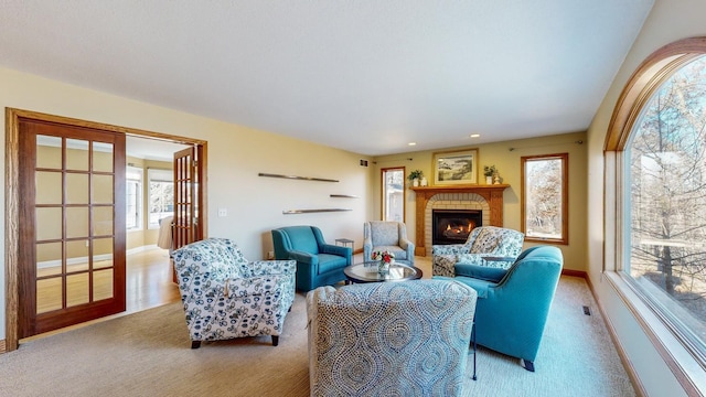 living room with a fireplace and light carpet