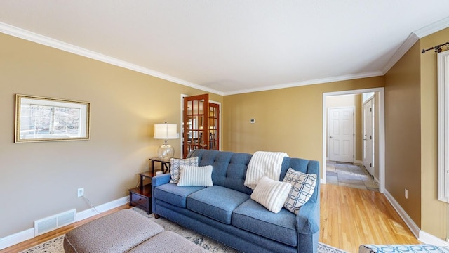 living room featuring hardwood / wood-style flooring and ornamental molding