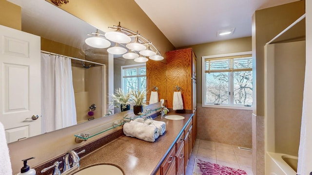 bathroom with vanity, tile patterned floors, shower / bath combination with curtain, and a healthy amount of sunlight