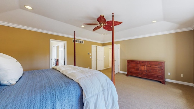 carpeted bedroom with ceiling fan, ornamental molding, and a tray ceiling