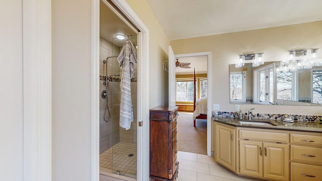 bathroom with vanity, tile patterned flooring, and a tile shower