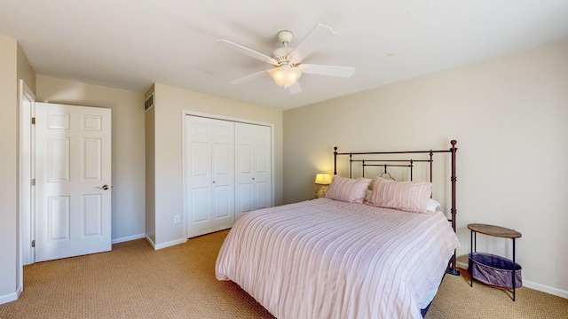 carpeted bedroom featuring ceiling fan and a closet