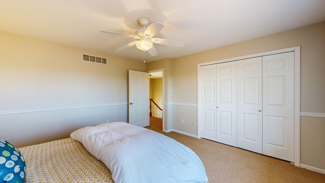 bedroom with a closet, ceiling fan, and carpet