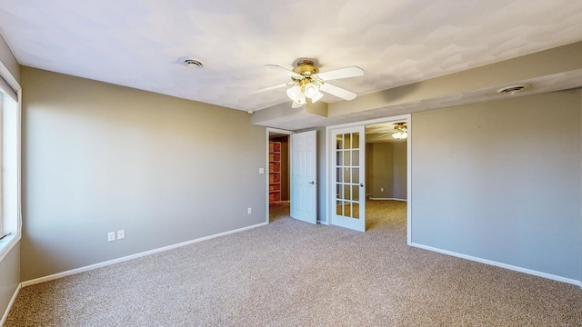 unfurnished bedroom with a closet, french doors, ceiling fan, and carpet