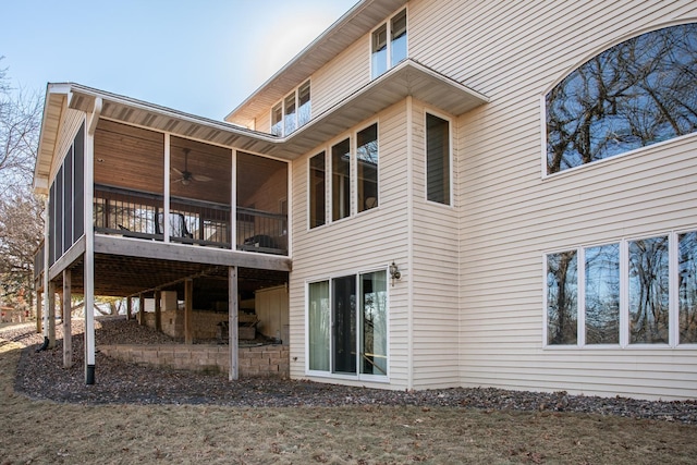 back of house with a sunroom and ceiling fan