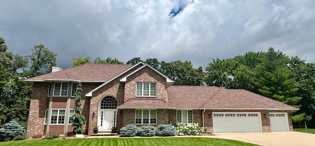 view of front of property with a garage and a front lawn