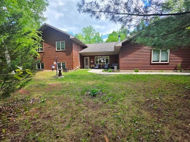 112 Bay Rd, Coleraine, MN 55722 - back of house featuring a lawn and a patio area