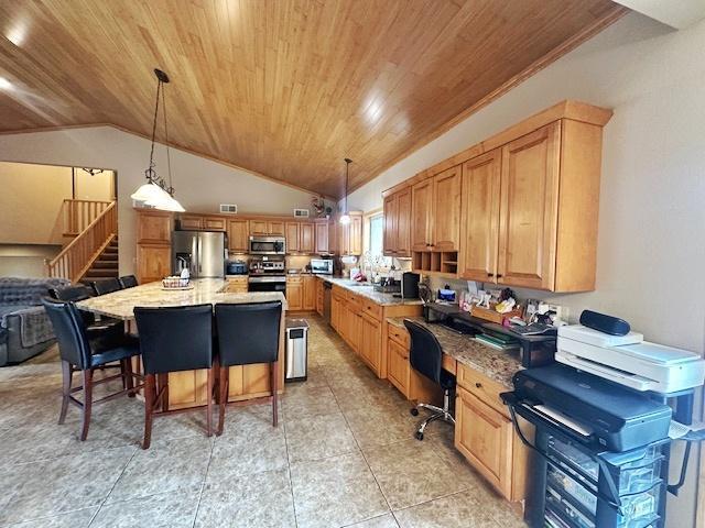 112 Bay Rd, Coleraine, MN 55722 - kitchen featuring stainless steel appliances, wooden ceiling, lofted ceiling, hanging light fixtures, and a breakfast bar