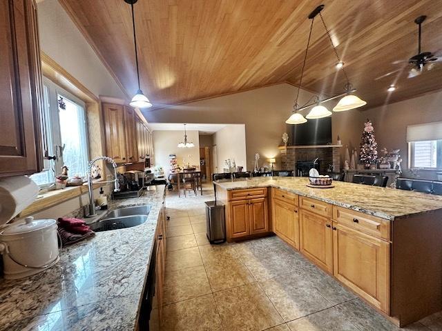 112 Bay Rd, Coleraine, MN 55722 - kitchen featuring wood ceiling, vaulted ceiling, a sink, light stone counters, and decorative light fixtures