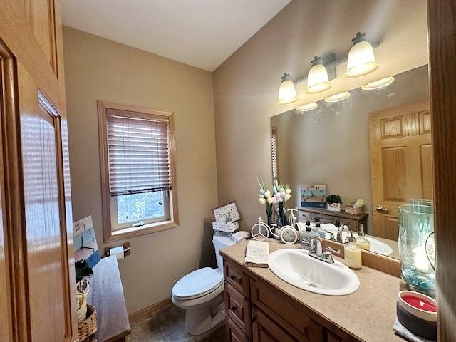 112 Bay Rd, Coleraine, MN 55722 - bathroom with vanity, toilet, and tile patterned floors