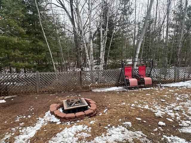 112 Bay Rd, Coleraine, MN 55722 - yard layered in snow with an outdoor fire pit