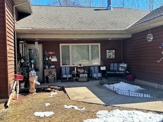 112 Bay Rd, Coleraine, MN 55722 - property entrance with a shingled roof and a patio area