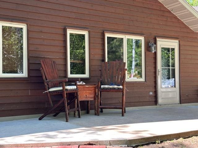 112 Bay Rd, Coleraine, MN 55722 - doorway to property featuring a patio area and outdoor dining space