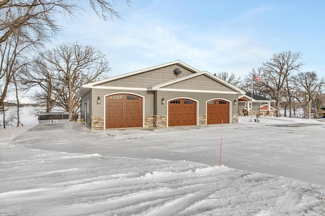 view of snow covered exterior featuring a garage