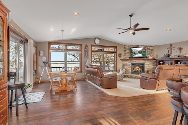 living room featuring lofted ceiling, a fireplace, dark hardwood / wood-style floors, and ceiling fan