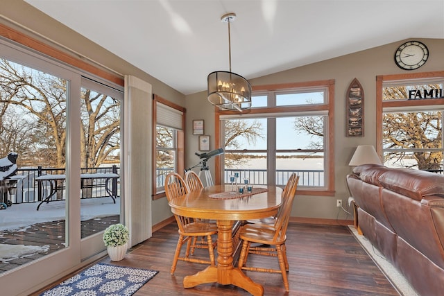 dining area featuring vaulted ceiling, dark hardwood / wood-style floors, and a notable chandelier