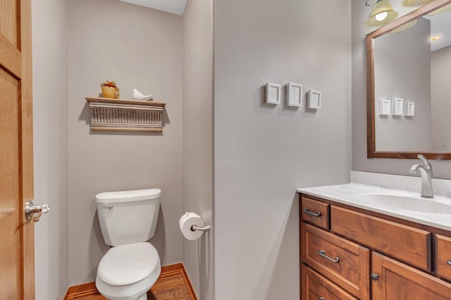 bathroom featuring vanity, toilet, and hardwood / wood-style floors