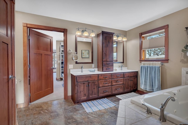 bathroom with vanity and tiled bath