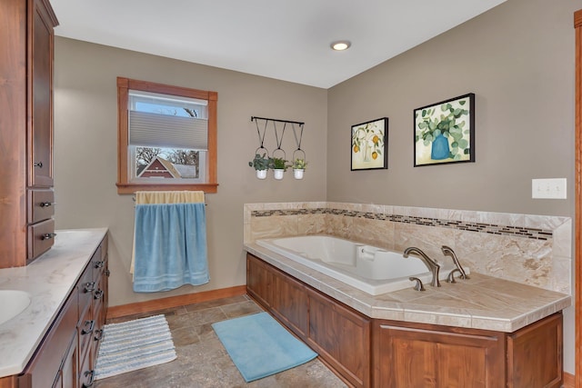 bathroom with vanity and a tub to relax in