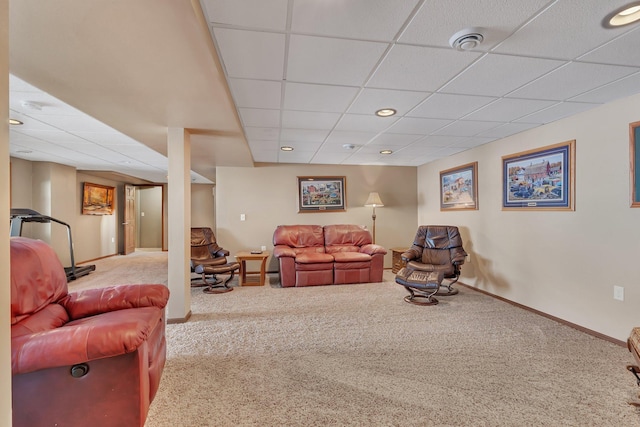 carpeted living room with a paneled ceiling