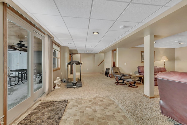 exercise area featuring a drop ceiling, ceiling fan, and carpet