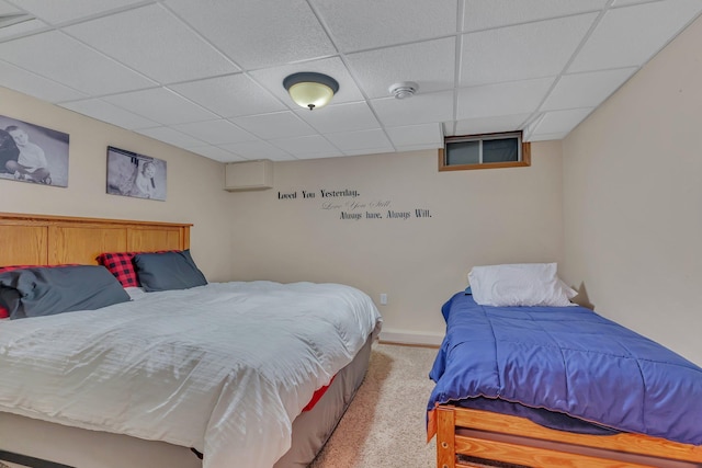 bedroom with a paneled ceiling and carpet flooring