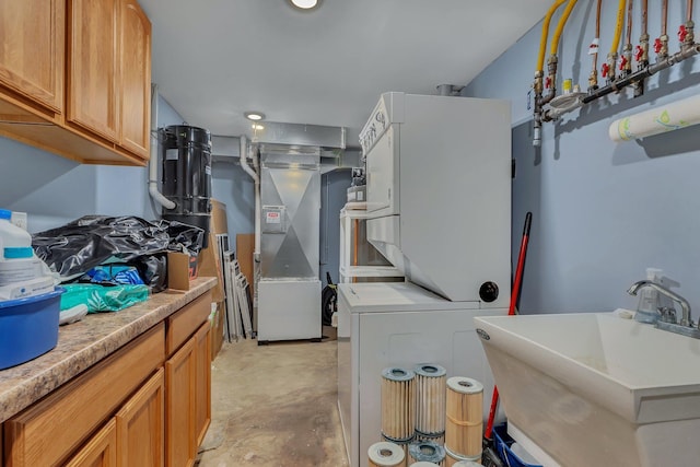 laundry room featuring stacked washer and clothes dryer, sink, and heating unit