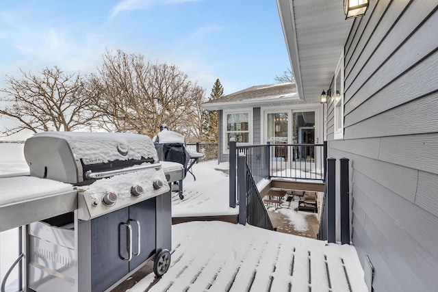 snow covered deck featuring a grill