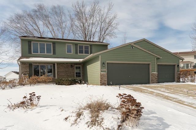 traditional-style house featuring a garage and brick siding