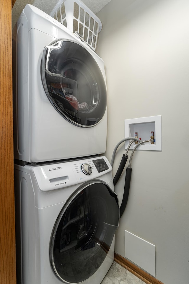 laundry area featuring laundry area and stacked washer / drying machine