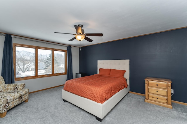 carpeted bedroom with a ceiling fan and baseboards