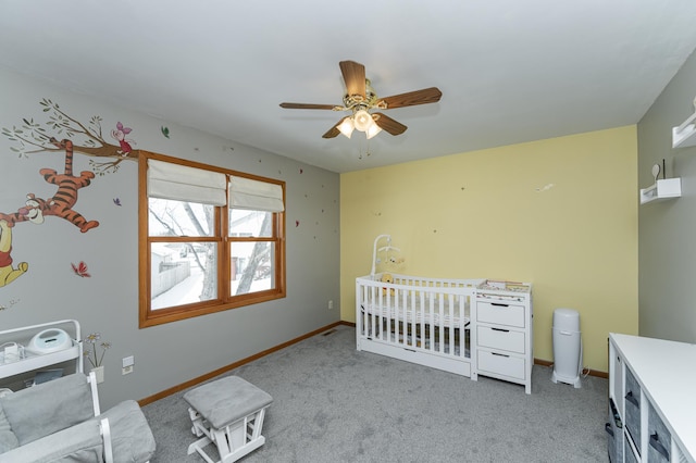 unfurnished bedroom featuring a nursery area, light colored carpet, and baseboards