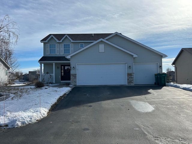 view of front of home featuring a porch and a garage