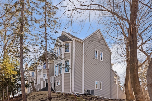 view of property exterior featuring stairs and central AC