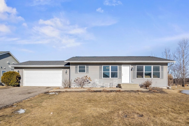 single story home featuring a garage and a front yard