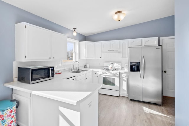 kitchen featuring sink, light hardwood / wood-style floors, white cabinets, and appliances with stainless steel finishes