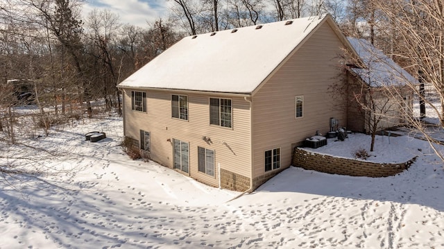 view of snow covered back of property