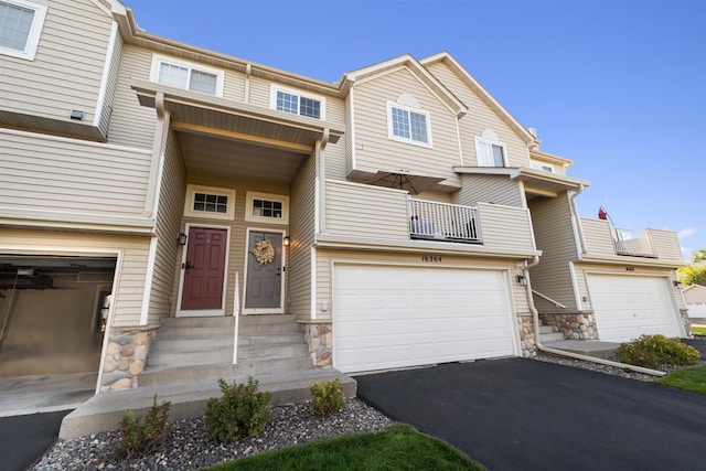 view of property featuring a garage and a balcony